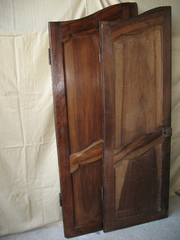 Pair of Louis XV style walnut paneled doors, 19th century