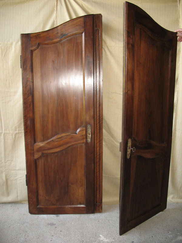 Pair of Louis XV style walnut paneled doors, 19th century