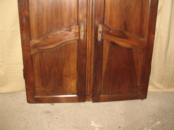 Pair of Louis XV style walnut paneled doors, 19th century