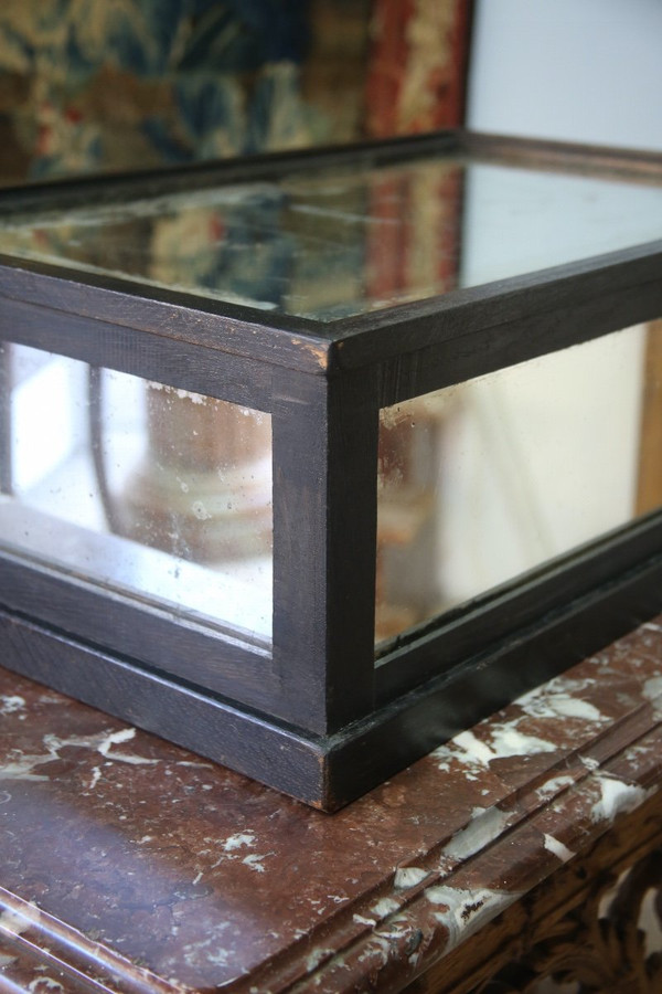 Large blackened wood base and mercury mirror.