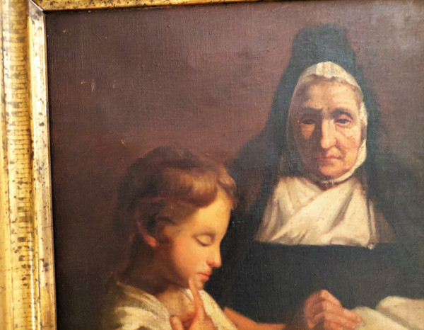 Oil on canvas scene of a nun giving a catechism lesson to a child