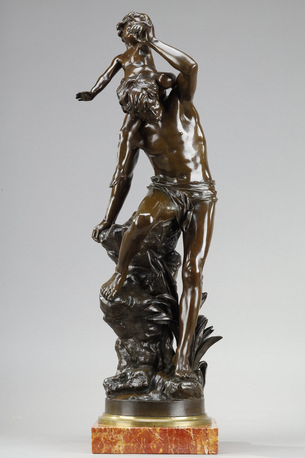 BROWN PATINA BRONZE OF A MAN CARRYING A CHILD ON HIS BACK, BY GASTON LEROUX (1854-1942)