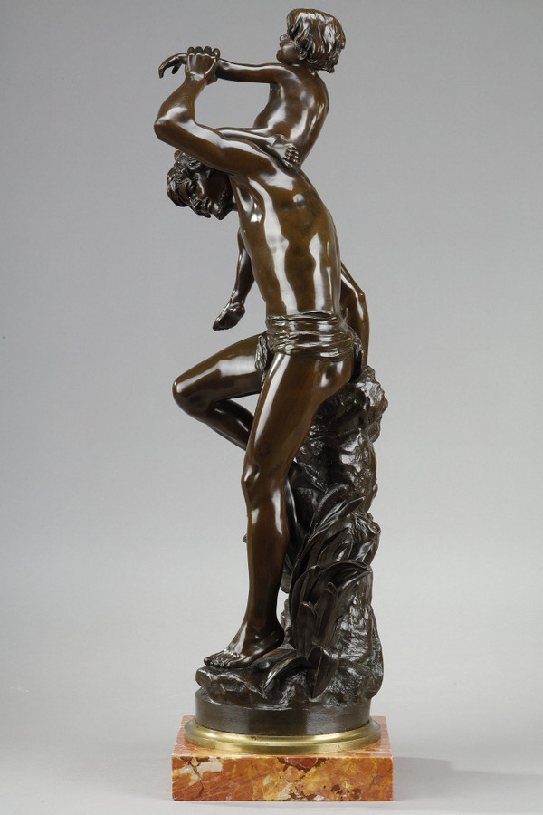 BROWN PATINA BRONZE OF A MAN CARRYING A CHILD ON HIS BACK, BY GASTON LEROUX (1854-1942)