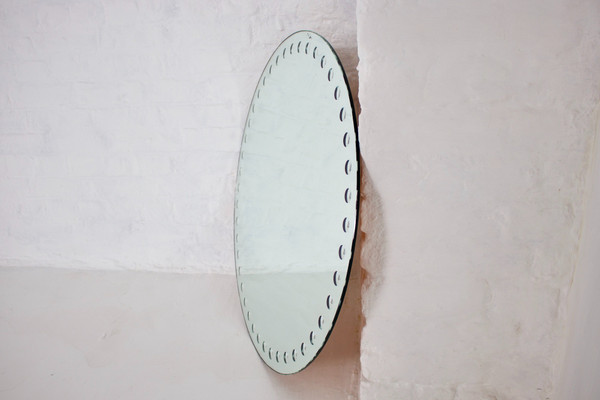 Large Fornasetti style optical mirror.