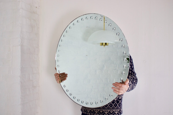 Large Fornasetti style optical mirror.