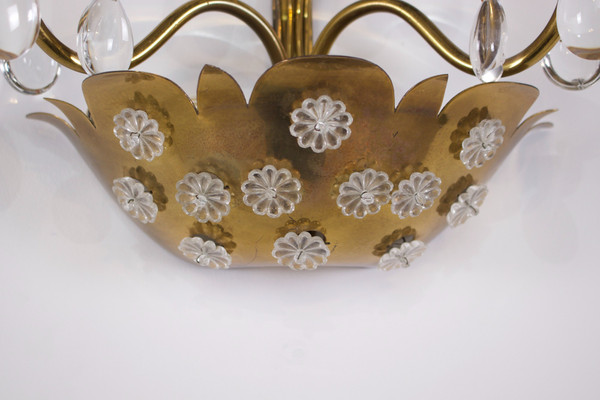 Brass floral sconce with pendants.