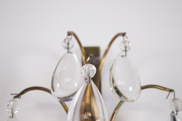 Brass floral sconce with pendants.