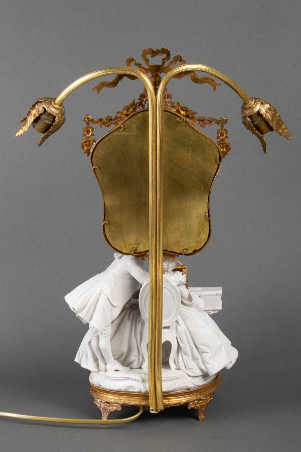 A romantic group in biscuit mounted lamp late 19th century