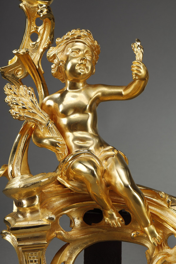 PAIR OF GILDED ANDIRONS IN THE LOUIS XV STYLE BRONZE