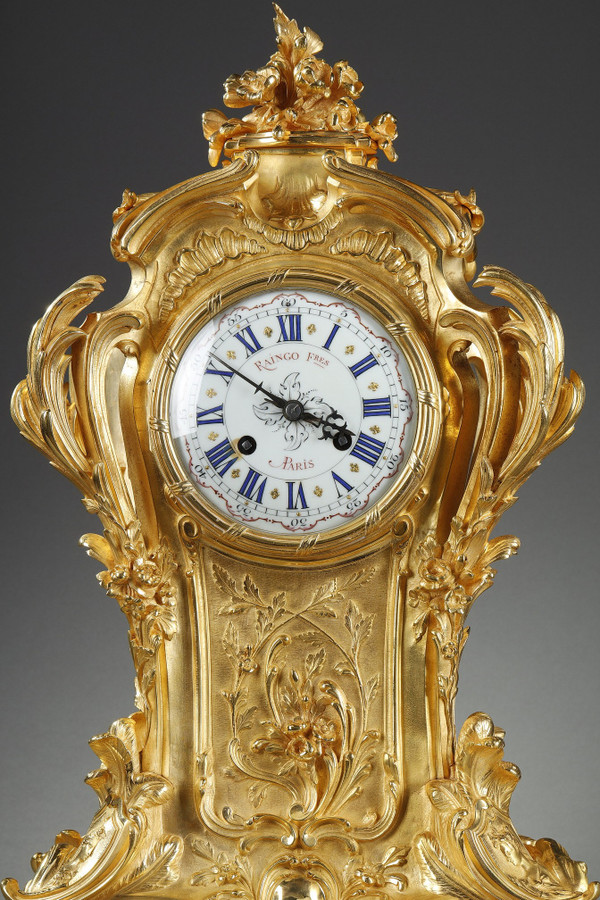 ORMOLU AND CHASED BRONZE ROCAILLE CLOCK, RAINGO AND BROTHERS 