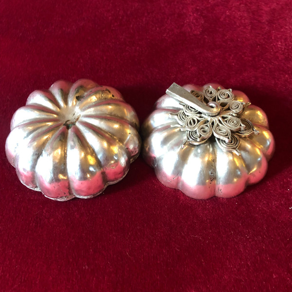 Two foreign silver pumpkins