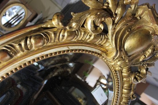 Antique Napoleon III oval mirror in gilded Louis XV style