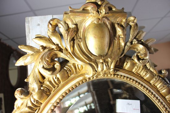 Antique Napoleon III oval mirror in gilded Louis XV style