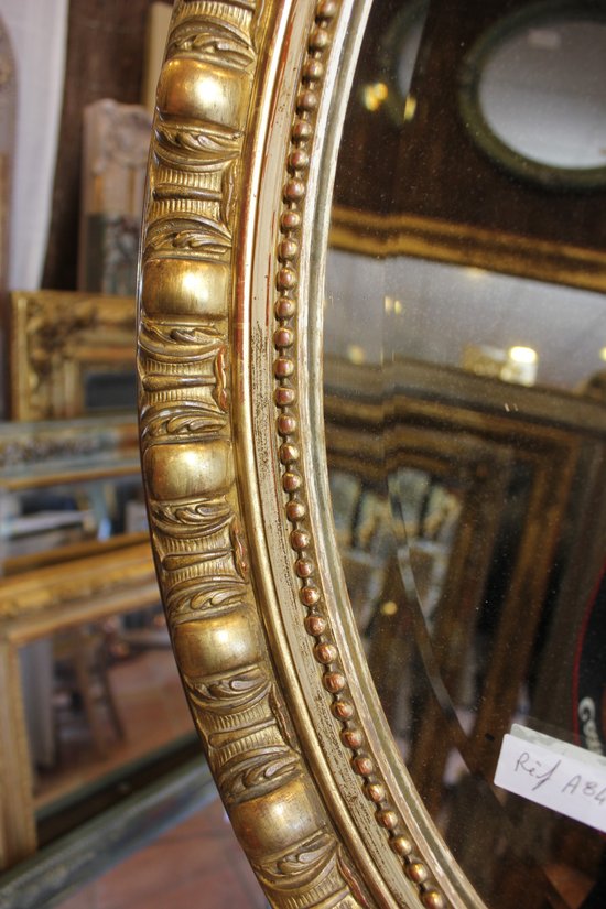 Antique Napoleon III oval mirror in gilded Louis XV style