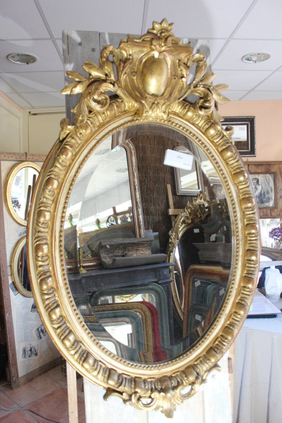 Antique Napoleon III oval mirror in gilded Louis XV style