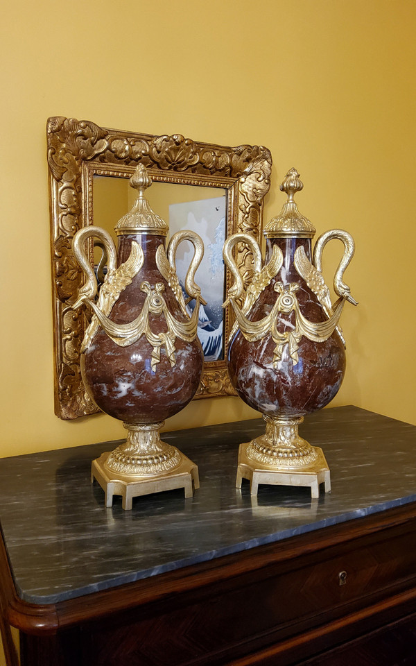 Pair of Red Marble Vases with gilded bronzes and swans in the Louis XVI style, late 19th century.