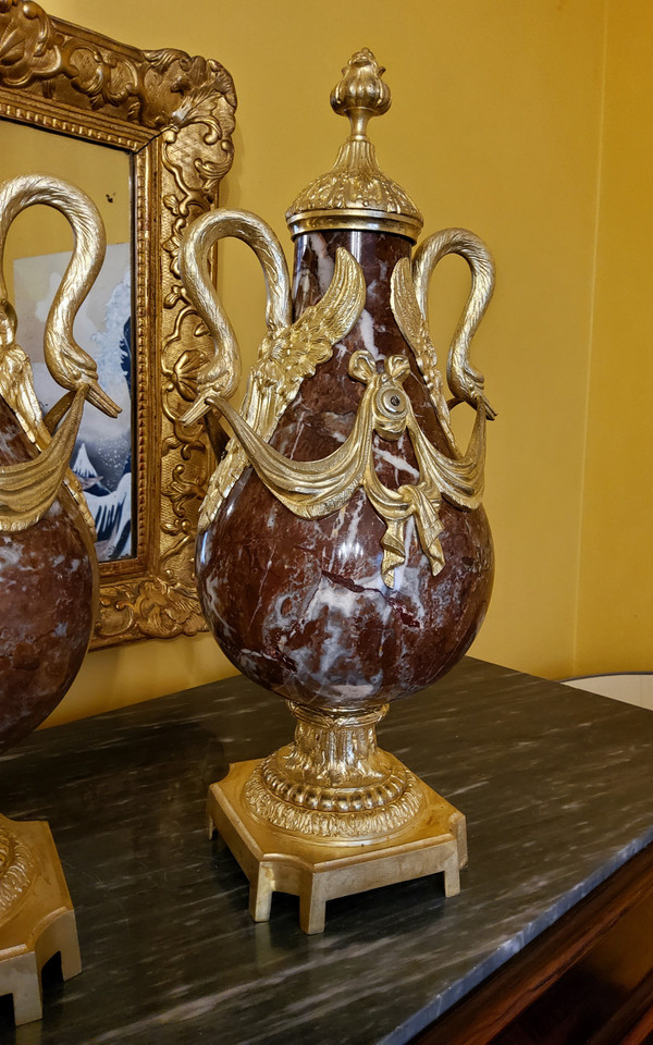 Pair of Red Marble Vases with gilded bronzes and swans in the Louis XVI style, late 19th century.