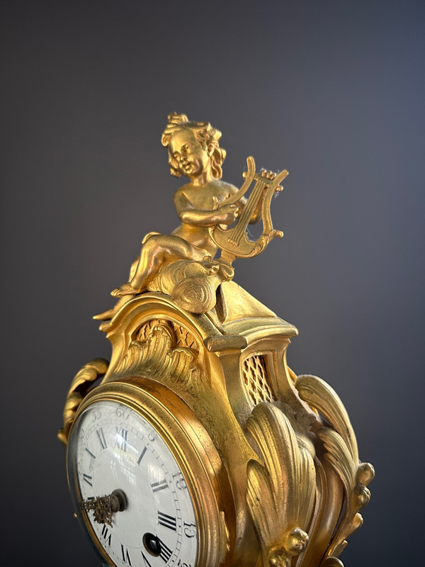 Orologio in bronzo dorato stile Luigi XV XIX secolo