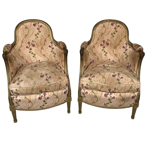 Paire de bergères en bois doré garnies de soie à motifs de fleurs, art déco d’inspiration Louis XVI