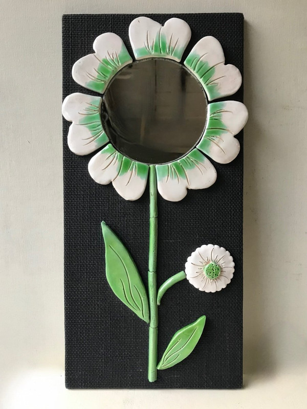 Ceramic flower mirror.