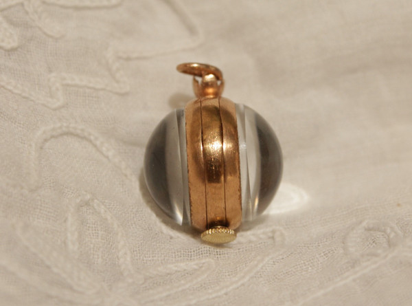 Small ball watch pendant with visible winding mechanism, 20th century period