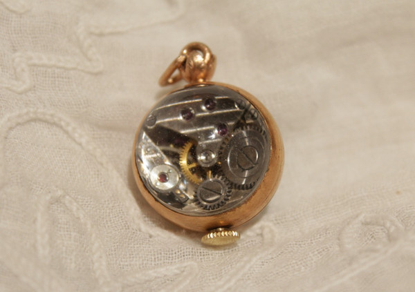 Small ball watch pendant with visible winding mechanism, 20th century period