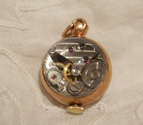 Small ball watch pendant with visible winding mechanism, 20th century period