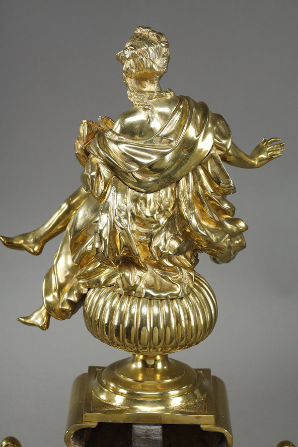 PAIR OF ORMOLU AND CHASED ANDIRONS DECORATED WITH SEATED MUSES