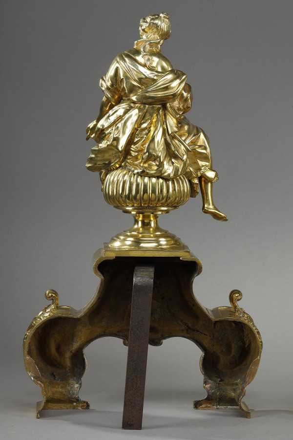 PAIR OF ORMOLU AND CHASED ANDIRONS DECORATED WITH SEATED MUSES