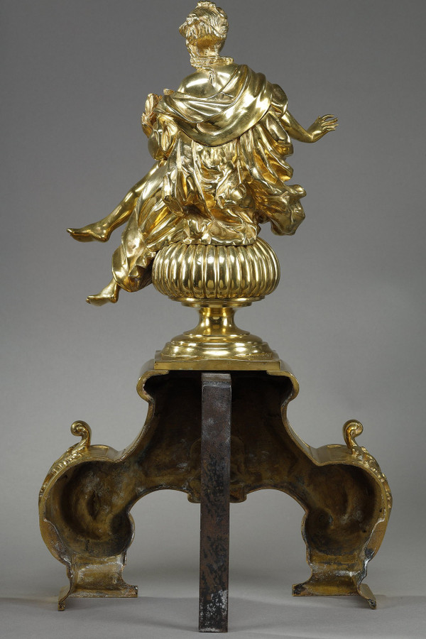 PAIR OF ORMOLU AND CHASED ANDIRONS DECORATED WITH SEATED MUSES