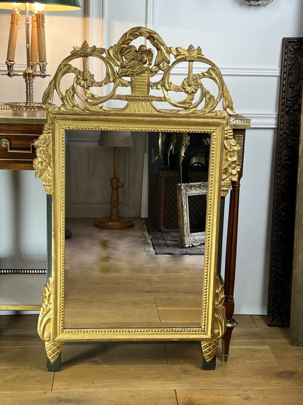 MIROIR EN BOIS SCULPTÉ DORÉ AVEC FRONTON AJOURÉ A DECOR DE FLEURS STYLE L.XVI