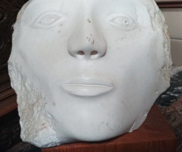 Face bust stone sculpture