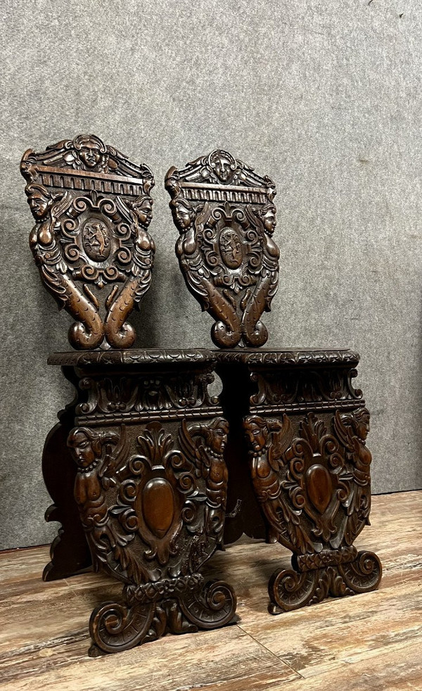 Pair of Venetian "sgabelli" chairs in richly carved walnut