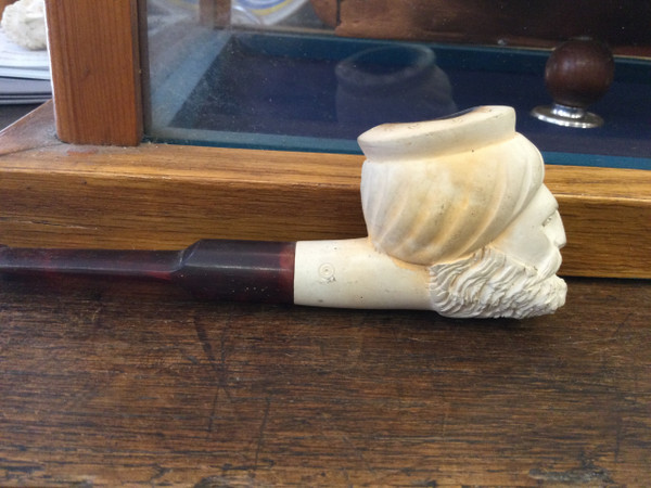 Carved head, pipe