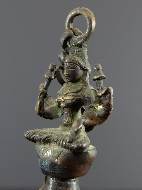 India, Mid-20th Century, Bronze bell adorned with a representation of the goddess Tripura.