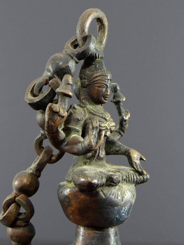 India, Mid-20th Century, Bronze bell adorned with a representation of the goddess Tripura.