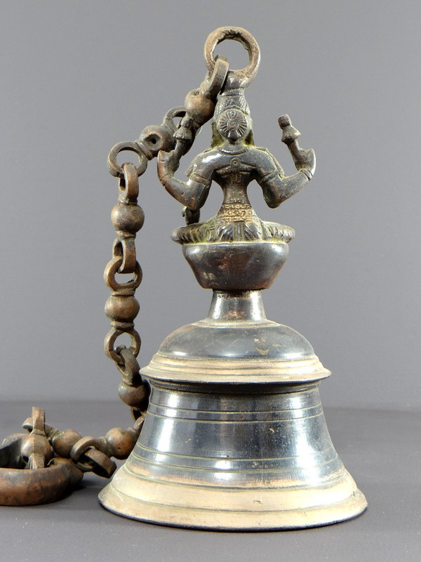 India, Mid-20th Century, Bronze bell adorned with a representation of the goddess Tripura.