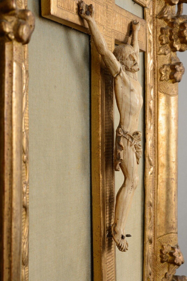 18th-century hand-carved Christ, gilded wood frame, floral decoration