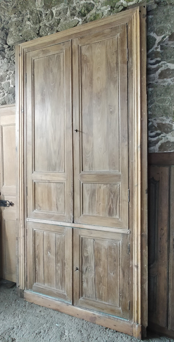 Two antique double cupboard doors in noble wood with their front woodwork frame