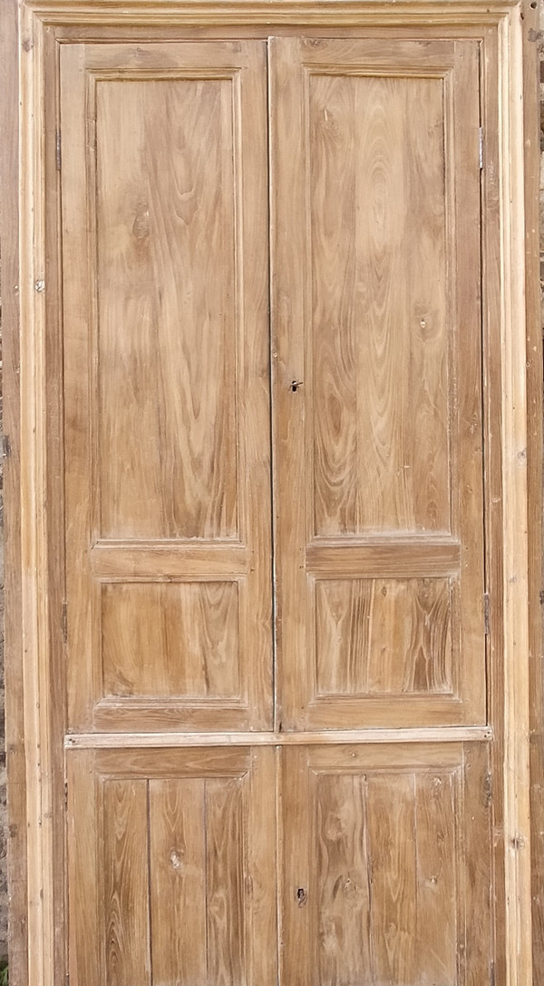 Two antique double cupboard doors in noble wood with their front woodwork frame