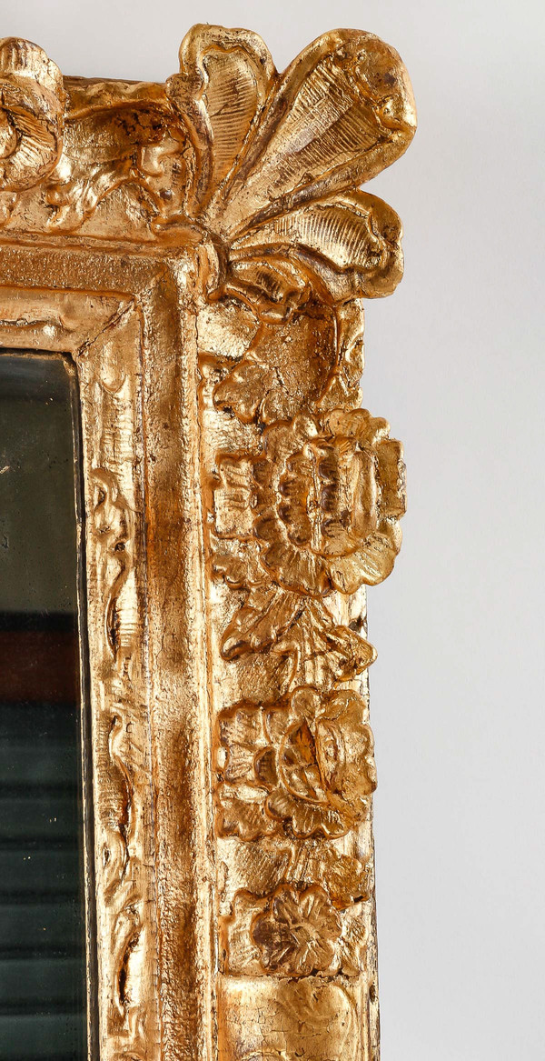 A French Regence period carved and gilt wood and stucco mirror circa 1720