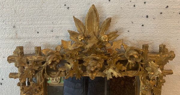 Louis XVI style mirror in carved wood and gilded with gold leaf, 19th century