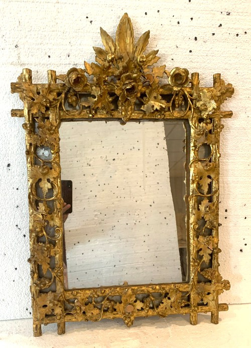 Louis XVI style mirror in carved wood and gilded with gold leaf, 19th century