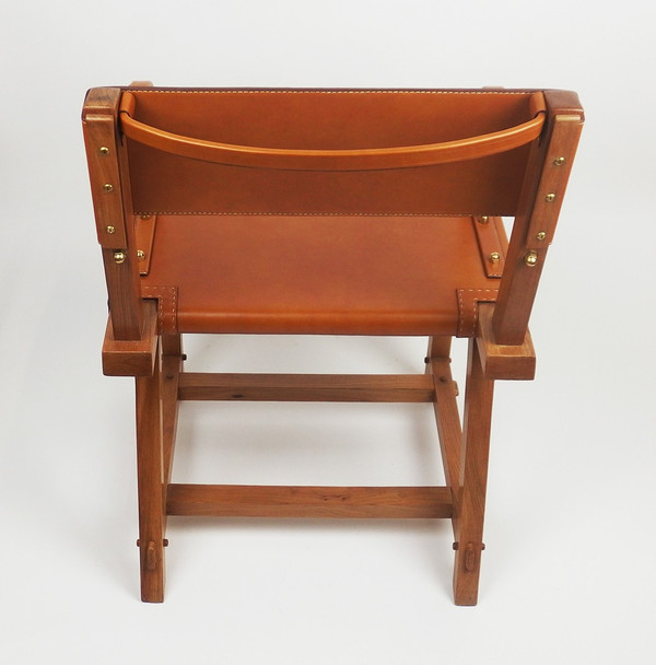 Leather armchair by Jacques Adnet