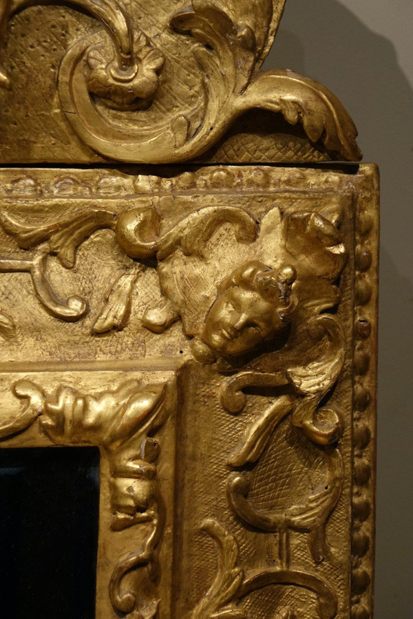 Large gilded wooden pediment mirror, Provence or Italy, 18th century.