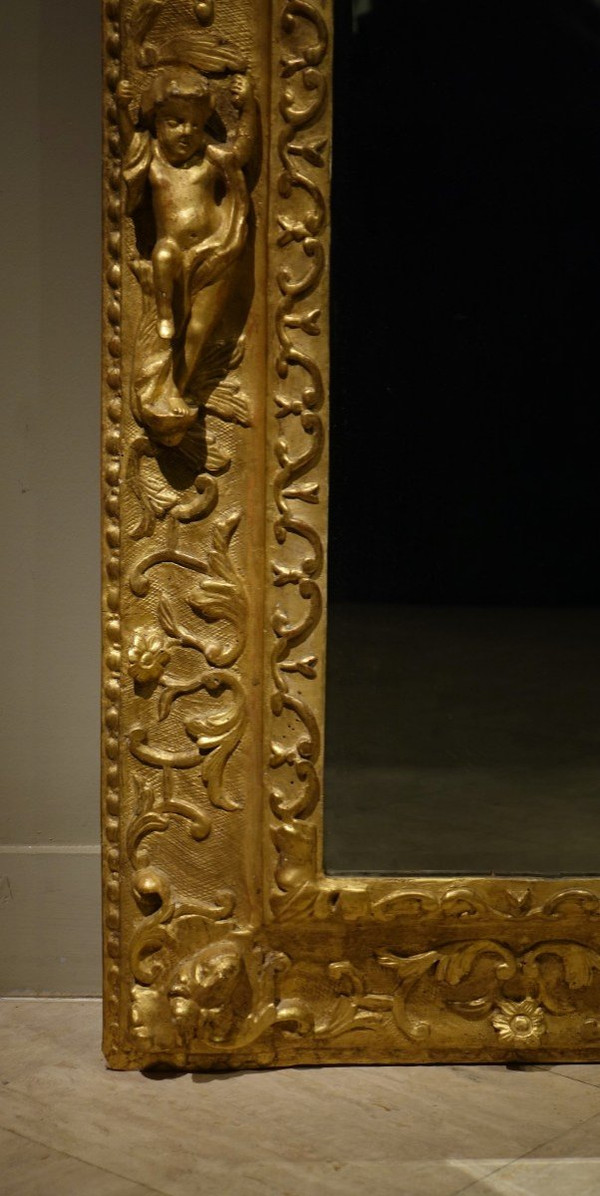 Large gilded wooden pediment mirror, Provence or Italy, 18th century.