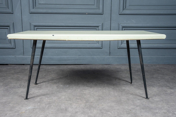 1960 coffee table with cream-colored top and designer tubular legs