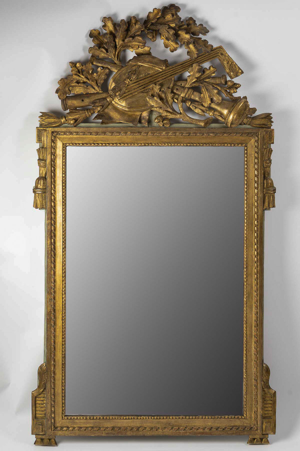 A large openwork pediment mirror in carved and gilded wood with musical attributes from the Louis XV