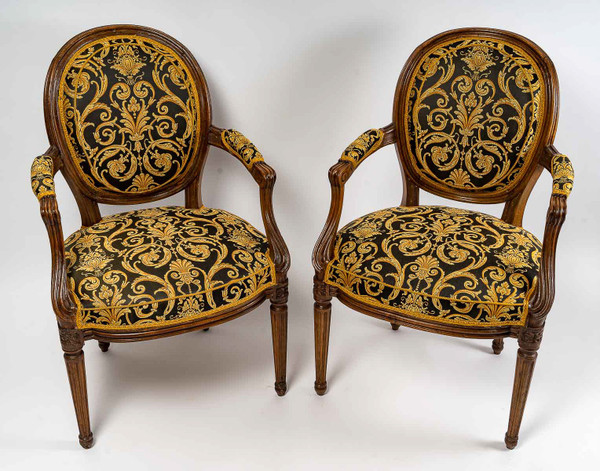 Pair of Louis XVI-style armchairs with medallion backs in carved and waxed molded natural wood