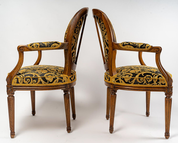 Pair of Louis XVI-style armchairs with medallion backs in carved and waxed molded natural wood